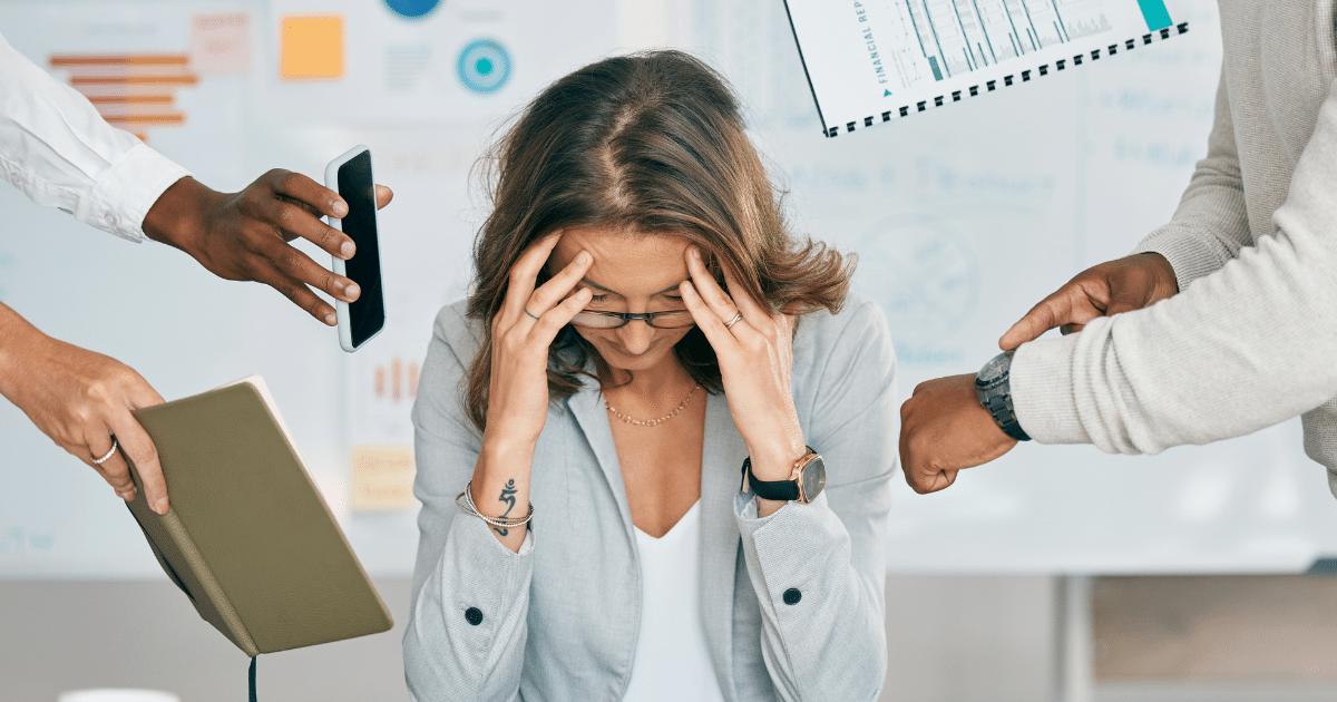 Stressed businesswoman overwhelmed by multiple tasks and demands.